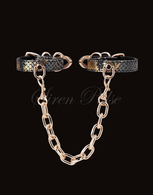 Siren Pulse GILT BIND gold chain handcuffs with snake print and gold buckles
